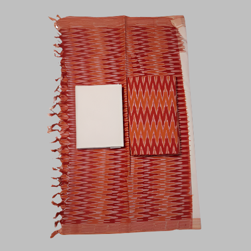 Orange and white patterned fabric with fringe on a white background