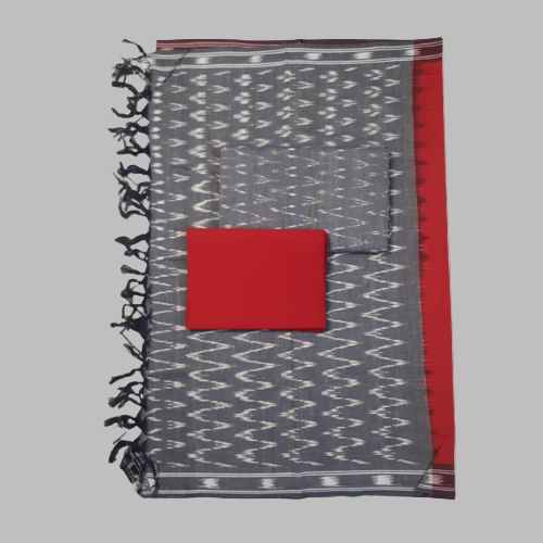 Gray patterned fabric with a red square and black tassels on a white background