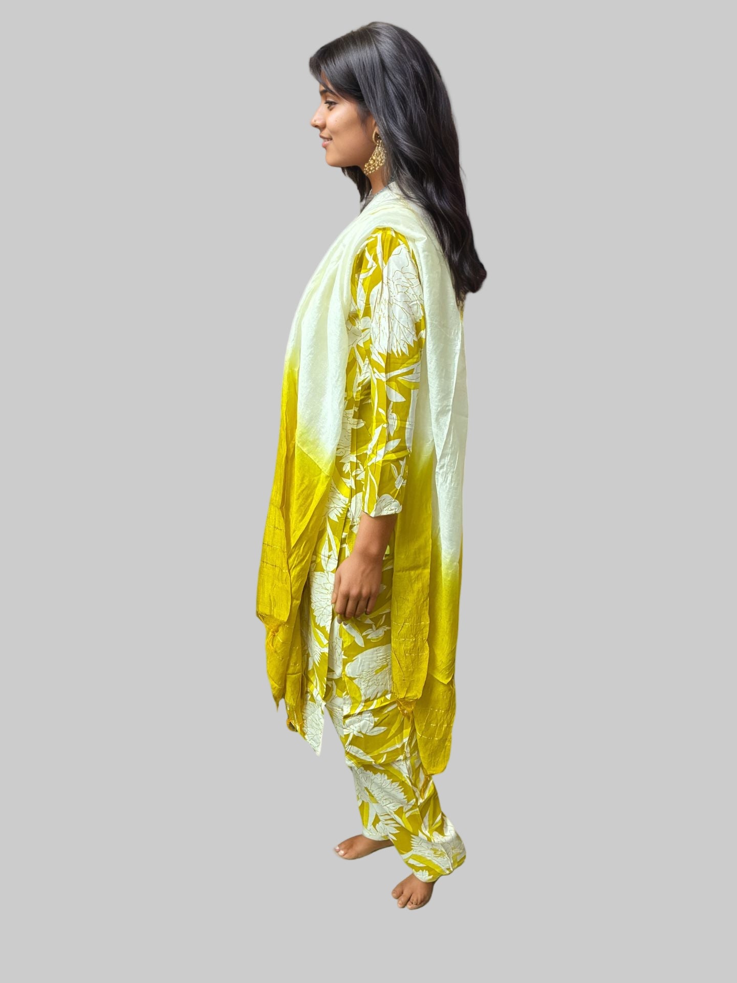 Woman wearing a yellow and white traditional outfit on a white background