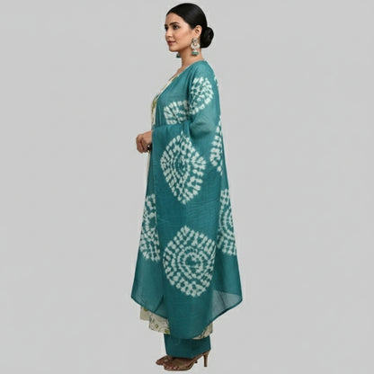 Woman wearing a floral kurta with a matching dupatta on a gray background