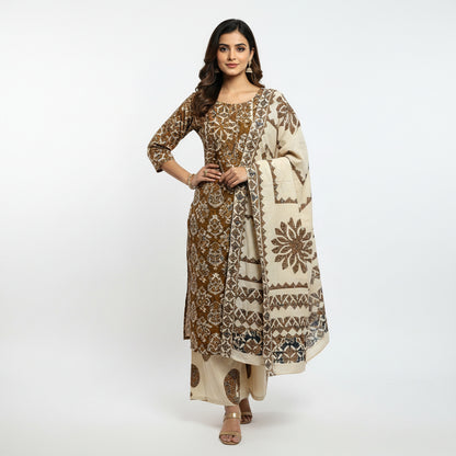 Traditional embroidered clothing on a floral-patterned bedspread