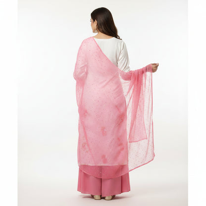 Woman wearing a pink and white traditional outfit with a matching dupatta on a white background