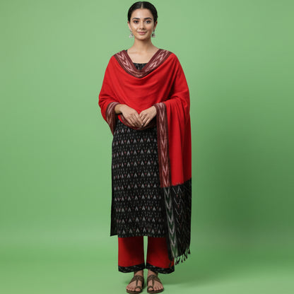 Woman wearing a black and red traditional outfit with a red scarf on a white background