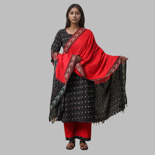 Woman wearing a black and red traditional outfit with a red scarf on a white background