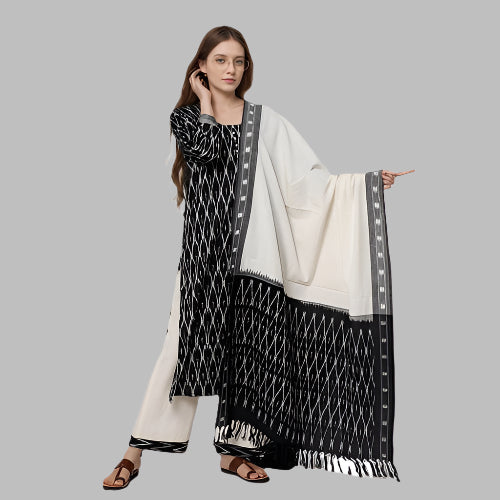 Woman wearing a black and white patterned dupatta on a white background