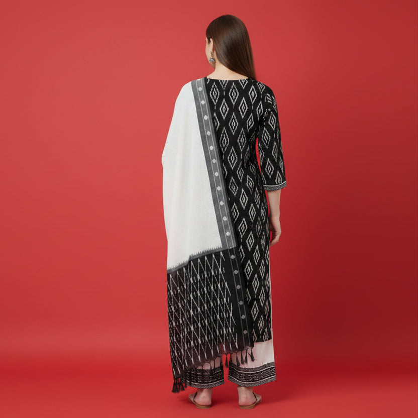 Woman wearing a black and white patterned outfit with a scarf on a white background