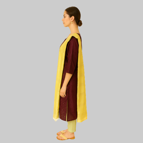 Woman wearing a maroon kurta with a yellow dupatta on a white background