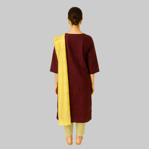 Woman wearing a maroon and yellow traditional outfit on a white background