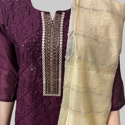 Purple and beige traditional outfit with intricate patterns on a white background