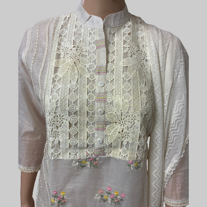 Traditional embroidered white outfit on a mannequin with a white background