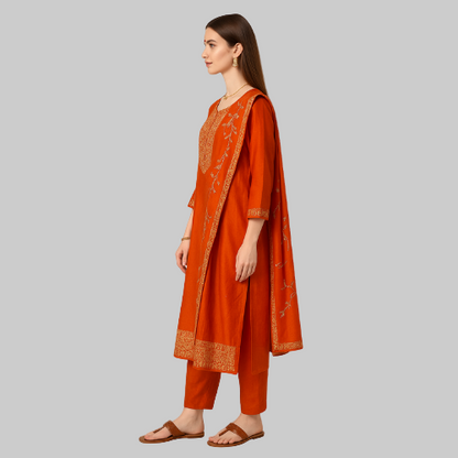 Woman wearing an orange traditional outfit with a matching dupatta on a white background