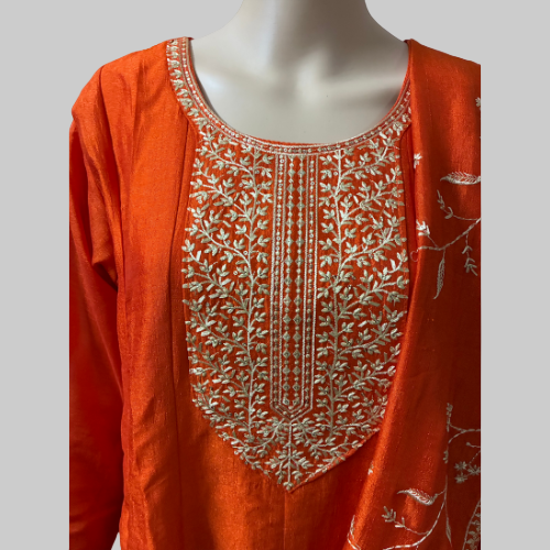 Orange kurta with white embroidery on a mannequin against a white background