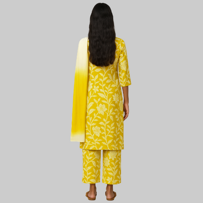Woman wearing a yellow floral outfit with a matching dupatta on a white background