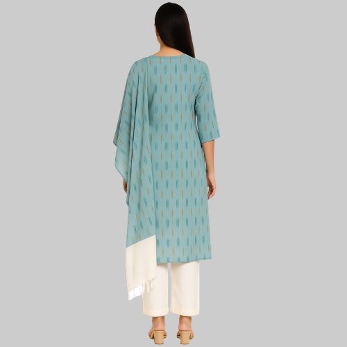 Woman wearing a light blue patterned kurta with white pants on a white background