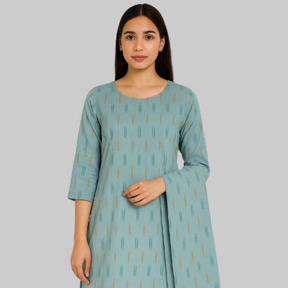 Woman wearing a teal dress with a subtle pattern on a white background