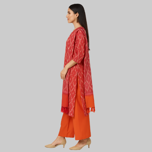 Woman wearing a red and orange traditional outfit with a white background