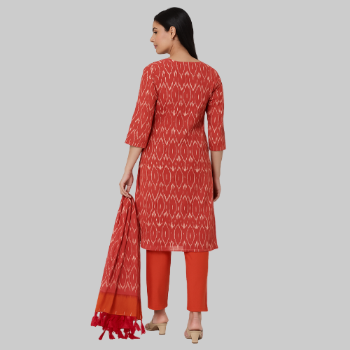 Woman wearing a red and white patterned kurta with matching pants on a white background