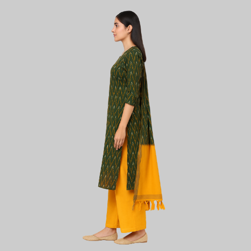 Woman wearing a green and yellow traditional outfit on a white background