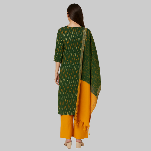 Woman wearing a green and yellow traditional outfit with a white background