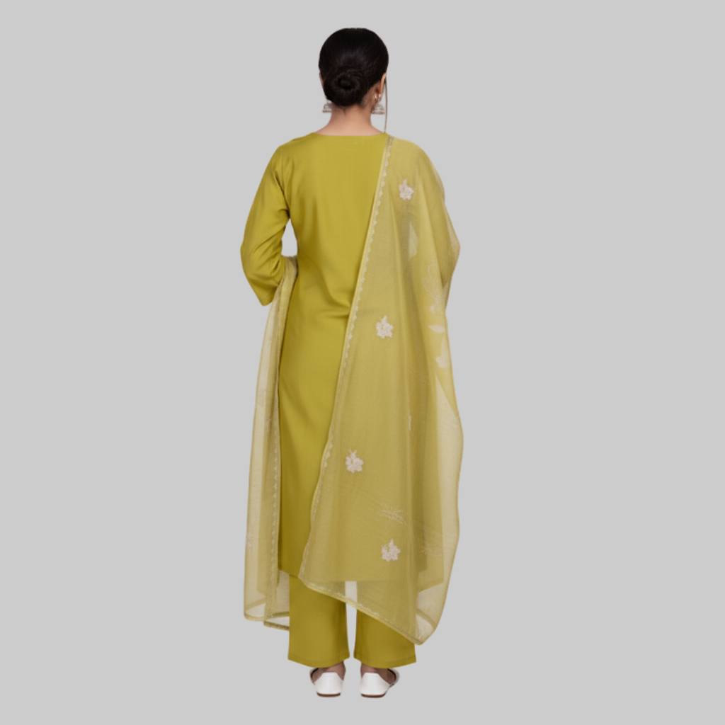 Woman wearing a green traditional outfit with a matching dupatta on a white background