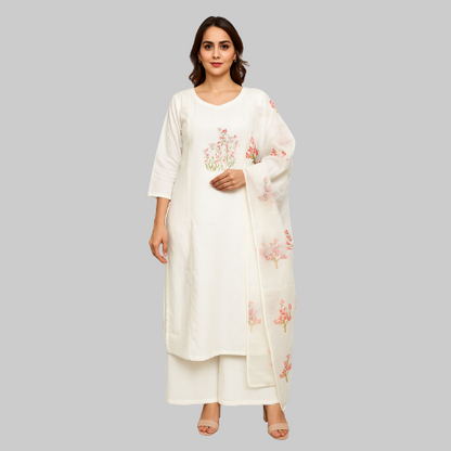 Woman wearing a white outfit with floral embroidery on a white background