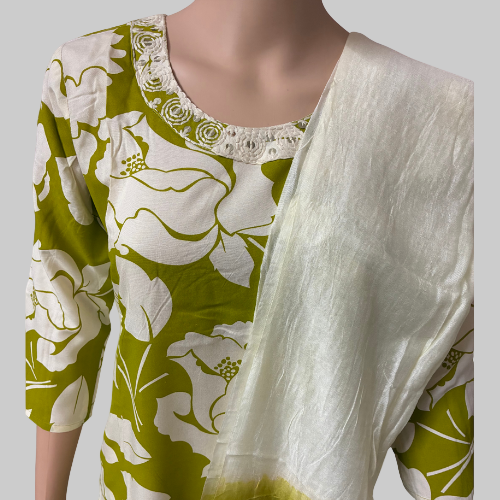 Green and white floral dress with a matching shawl on a mannequin against a white background