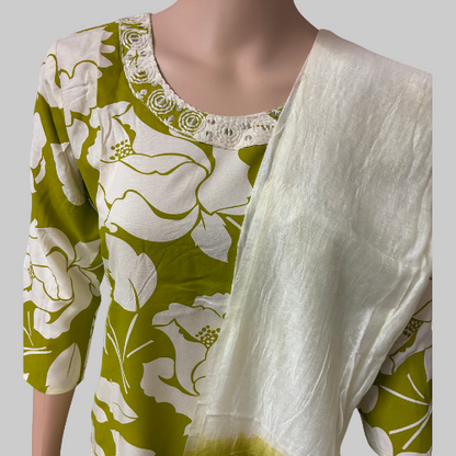 Green and white floral dress with a matching shawl on a mannequin against a white background